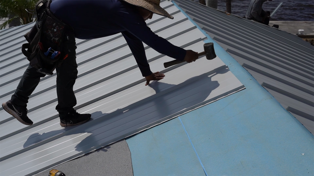 Right Way Roofing - Close up shot of roofer installing aluminum roofing